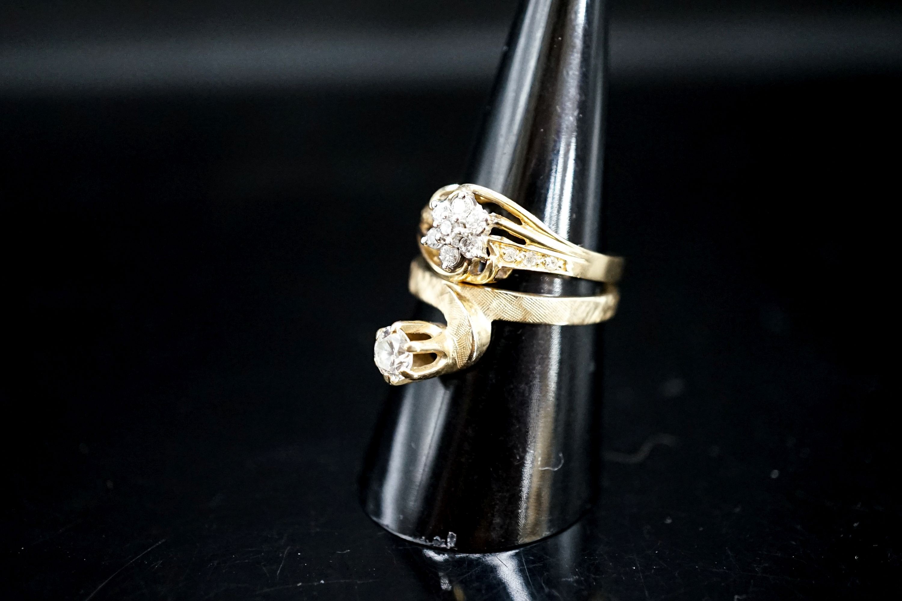 A modern 14k and solitaire diamond ring, size O/P and one other 14k and diamond cluster ring, gross 6.1 grams.